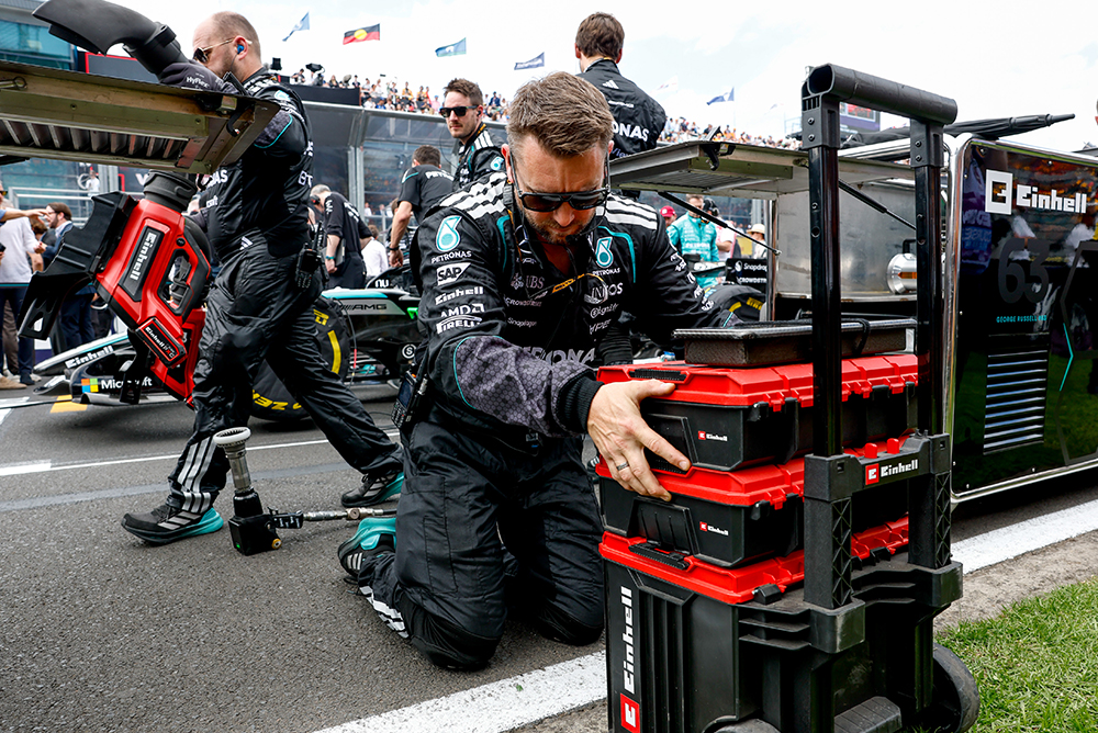 Formula 1 mechanic preparing a tool case in the pit lane.