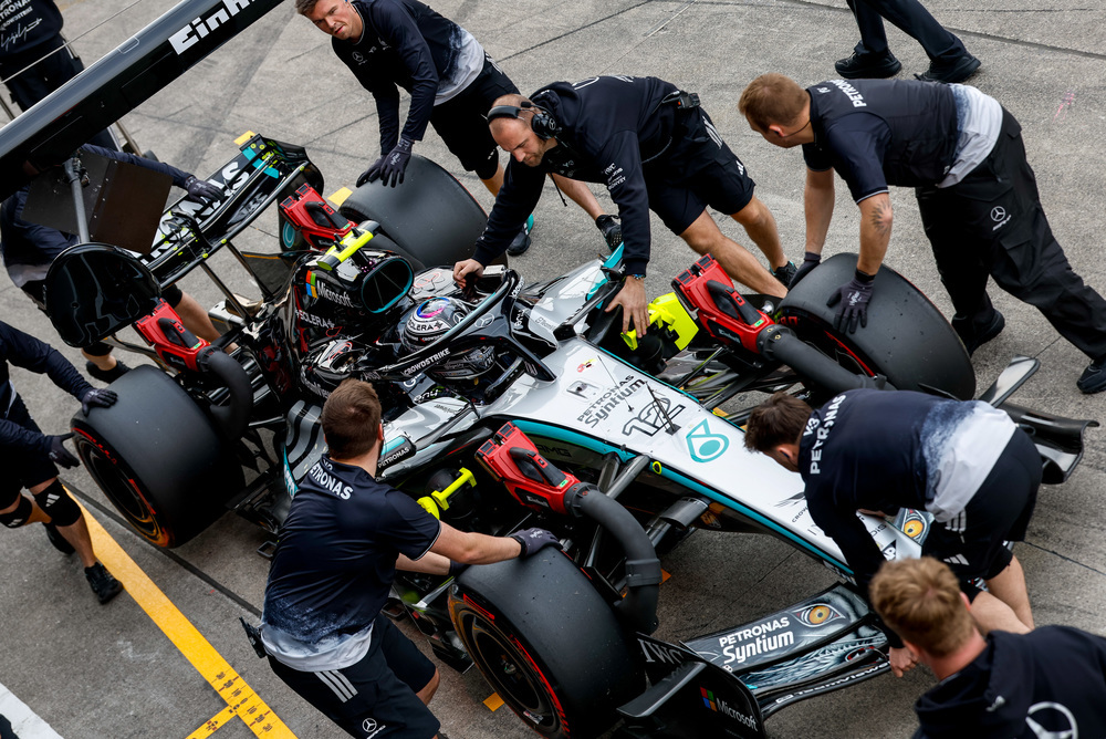 Mercedes pit crew servicing car during race stop